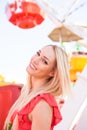 Happy pretty woman in front of a Ferris wheel Royalty Free Stock Photo