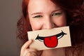 Happy pretty woman holding card with funny smiley Royalty Free Stock Photo