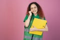 Happy, pretty woman standing with closed eyes, smiling, raising hand, holding folder. Royalty Free Stock Photo
