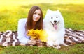 Happy pretty woman and white Samoyed dog having fun outdoors Royalty Free Stock Photo