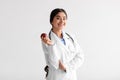 Happy pretty young indian woman doctor dentist in white coat with stethoscope hold fresh red apple Royalty Free Stock Photo