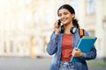Happy pretty young indian woman student talking on phone outdoor Royalty Free Stock Photo