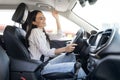 Happy pretty young woman driving car, listening to music Royalty Free Stock Photo