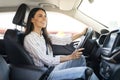 Happy pretty young woman driving car and smiling Royalty Free Stock Photo