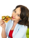 Happy Pretty Young Woman Eating a Slice of Freshly Baked Vegetarian Pizza