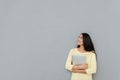 Happy pretty young woman holding laptop and looking away Royalty Free Stock Photo