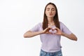 Happy pride love is love. Smiling cute woman kissing and showing heart sign, I like you gesture, celebrating lgbtq month Royalty Free Stock Photo