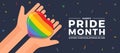 Happy pride month - top view hands hold rainbow pride haert on dark blue background vector design Royalty Free Stock Photo