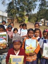 Happy primary school children with new books in west bengal in india