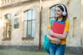 Happy primary school kid wear modern headphones listening to foreign language course of english, copy space