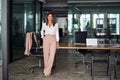 Happy mature business woman executive standing in office. Full body portrait.