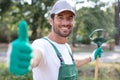 happy professional gardener with green gloves giving thumbs up