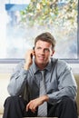 Happy professional getting news on phone Royalty Free Stock Photo