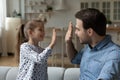 Happy proud dad and daughter giving high five