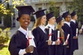 Happy and proud dark-skinned female student at graduation ceremony at university. Royalty Free Stock Photo