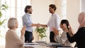 Happy proud manager handshake promote male worker, employee recognition concept
