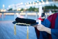 Happy proud PhD graduated male student in Academic dress gown holds Graduation cap or hat and diploma or certificate. Blurred