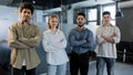 Happy proud professional group diverse business people stand in office with their arms crossed smile confidently looking Royalty Free Stock Photo