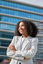 Happy proud young African American business woman standing in city, vertical. Royalty Free Stock Photo