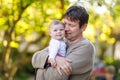 Happy proud young father having fun with newborn baby daughter, family portrait togehter. Dad with baby girl outdoors Royalty Free Stock Photo