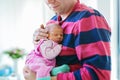 Happy proud young father holding his sleeping newborn baby daughter Royalty Free Stock Photo