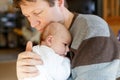 Happy proud young father with newborn baby daughter, family portrait togehter Royalty Free Stock Photo