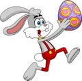 Happy Rabbit Cartoon Character Running With Colored Easter Egg Royalty Free Stock Photo