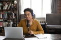 Happy radio channel newscaster in headphones speaking at microphone