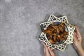 happy ramadan or eid concept, deglet nour algeria dates in stars plate, hands holding one piece.