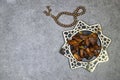 happy ramadan or eid concept, deglet nour algeria dates in stars plate with rosary tasbih,