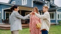 Happy Real Estate Agent Congratulating Young Homeowners with Their New Home Acquisition. Cheerful Royalty Free Stock Photo