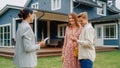 Happy Real Estate Agent Congratulating Young Homeowners with Their New Home Acquisition. Cheerful Royalty Free Stock Photo