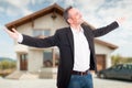 Happy realtor standing outside with arms outstretched