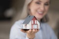 Happy realtor woman holding tiny house model on hand Royalty Free Stock Photo