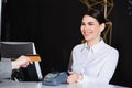 happy receptionist smiling near guest paying Royalty Free Stock Photo