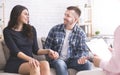 Cheerful millennial spouses smiling to each other at consultation Royalty Free Stock Photo