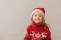 Happy Redhair girl in christmas jacket and santa hat