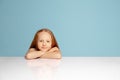 Happy redhair girl isolated on blue studio background. Looks happy, cheerful, sincere. Copyspace. Childhood, education