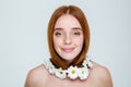 Happy redhair woman with neck of flowers