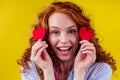 Happy redhead ginger curly girl businesswoman in a cotton shirt model hold decorative hearts Valentines Day gift on Royalty Free Stock Photo