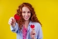 Happy redhead ginger curly girl businesswoman in a cotton shirt model hold decorative hearts Valentines Day gift on Royalty Free Stock Photo