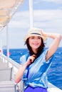 Girl in blue dress and hat have a voyage on a boat Royalty Free Stock Photo