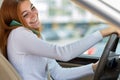 Happy redhead girl talking on her mobile phone behind the wheel driving a car Royalty Free Stock Photo