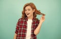 happy redhead woman with curly hair in checkered casual shirt, style