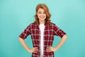 happy redhead woman with curly hair in checkered casual shirt, style