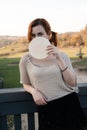 Happy redhead woman enjoys tradicional czech sweet waffer food Oplatky in the Pragu Zoo