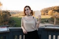 Happy redhead woman enjoys tradicional czech sweet waffer food Oplatky in the Pragu Zoo