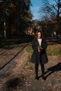 Happy redhead woman throwing and playing with autumn leaves starting fresh new life in Prague