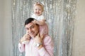 Happy relationship of handsome dad and cute daughter having fun at home. Portrait of father and toddler girl celebrate and enjoy