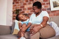 Happy, relax and a mother on the sofa with a child for conversation, bonding and family in a house. Smile, care and an Royalty Free Stock Photo